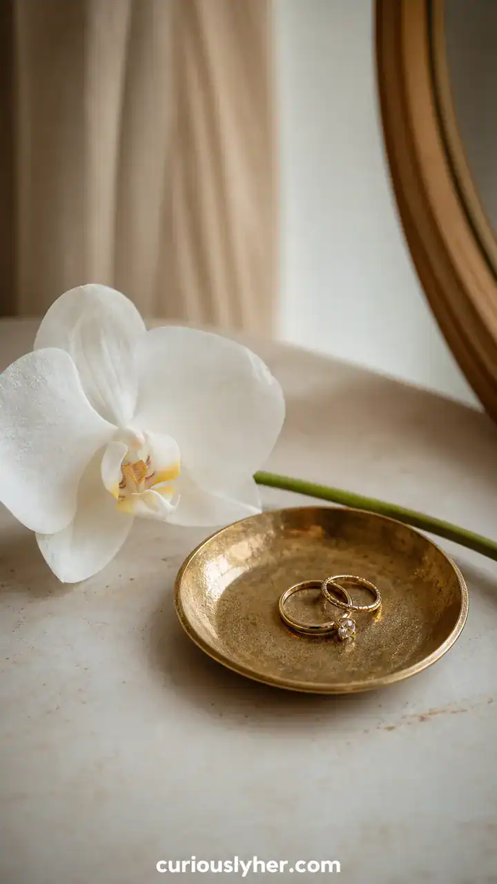 17. A Tiny Brass Dish Holding Rings Next to a Single White Orchid
